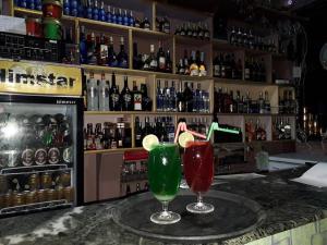 two cocktails sitting on a counter in a bar at Darsan Namaste in Meghauli
