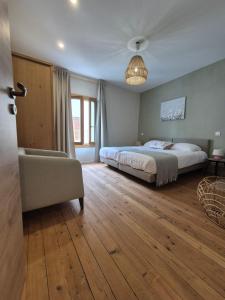 a bedroom with a bed and a couch and a window at Maison Ventoux Vacances in Bédoin