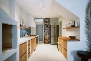 a kitchen with a stainless steel refrigerator and wooden cabinets at Villa Ines in Komiža