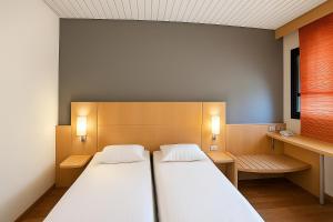 A bed or beds in a room at a&o Hostel Milano Ca Granda