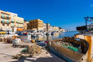 a group of boats are docked in a harbor at Pompeano House in Mazara del Vallo