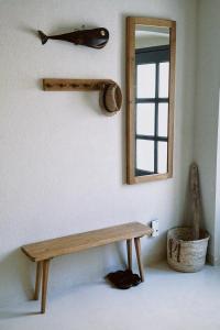 a wooden bench in a room with a mirror at Villa Ines in Komiža +21 photos