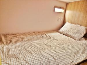 Postel nebo postele na pokoji v ubytování Onjeong Stay