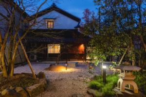 a house with a lantern in front of it at night at Auberge S'Amuser - Vacation STAY 96495v in Sakai