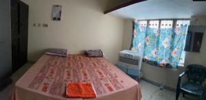 a hospital room with a bed and a window at Jaykishan sadan in Varanasi