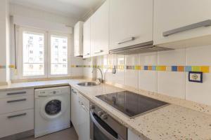 eine Küche mit Spüle und Waschmaschine in der Unterkunft Santander Centro I 4 hab I Ocio I Wifi I Moderno in Santander + 11 Fotos