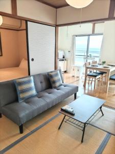a living room with a couch and a table at 指宿 潮音 Ibusuki Shione in Ibusuki +31 photos