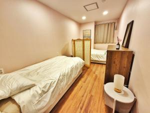 Postel nebo postele na pokoji v ubytování Onjeong Stay