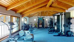a gym with several exercise equipment in a room at Hotel Alexanderhof in Millstatt