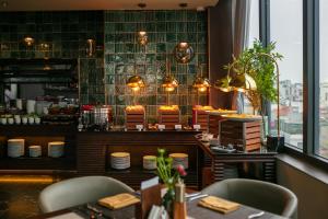 a restaurant with a table and chairs in a room at HOTEL de LAGOM in Hanoi