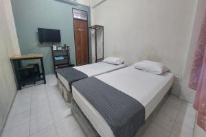 Postel nebo postele na pokoji v ubytování Sukhum Mega Bangna Guest House