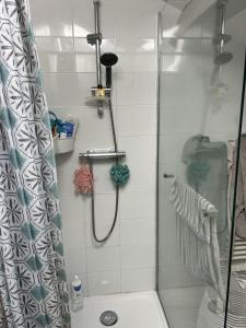 a shower with a glass door in a bathroom at Maison familiale entre océan, golf & forêt in Anglet +5 photos