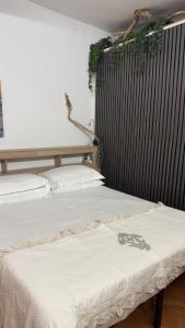 a pair of beds in a room with plants on the wall at Hotel Marina in Monterosso al Mare