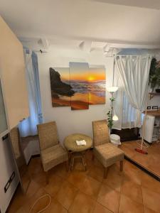 a living room with two chairs and a table at Hotel Marina in Monterosso al Mare