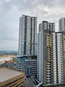 a group of tall buildings in a city at Apartment Deluxe Mesahill Nilai in Nilai