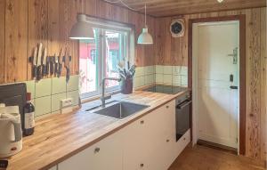 a kitchen with a sink and a counter top at Amazing Home In Aakirkeby With Wifi in Vester Sømarken