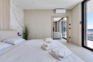 Postel nebo postele na pokoji v ubytování Apartina Boutique Suites