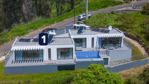 an overhead view of a house with solar panels on it at CASA PANORAMA SOL- NEW VILLA WITH HEATED SALTWATER POOL and FANTASTIC SEA VIEW in Ponta do Sol