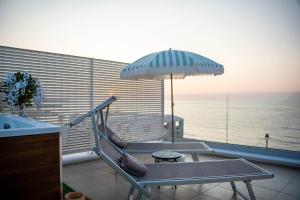 a balcony with a swing and an umbrella at Amarè Luxury Suite And Room Vista Mare in Bari
