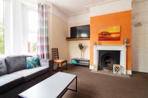 a living room with a couch and a fireplace at Thornbury Guest House Room 1 in Southampton