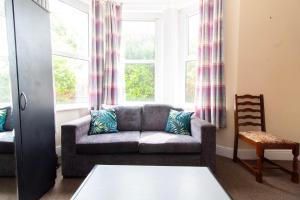a living room with a couch and a window at Thornbury Guest House Room 1 in Southampton