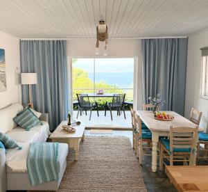 a living room with a couch and a table at Amara Blue Bay Villa in Kalamos