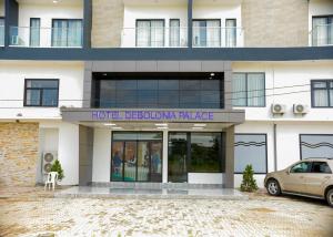 a building with a car parked in front of it at Debolonia Palace Hotel in Douala