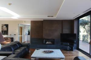a living room with a couch and a fireplace at Villa Calamocarro in Ceuta