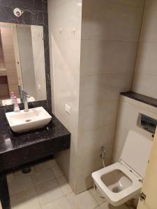 a bathroom with a sink and a toilet at Gaur City Mall Homestay in Ghaziabad
