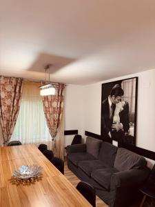 a living room with a couch and a table at Casa cu Cires Breaza in Podu Vadului +14 photos