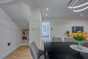 a dining room with a black table and chairs at Apartments Saladinka in Poreč