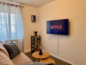a living room with a tv on a wall at MAIN Cozy Casa Peterplatz in Würzburg