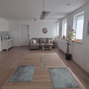 a living room with a couch and a table at Gasthaus Sonne 3 in Braunsbach