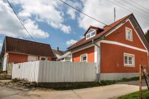 una casa roja y blanca con una valla blanca en Chalupa Hanička, en Štěměchy