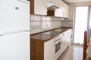 a kitchen with a sink and a refrigerator at TAO El Cotillo - VV in El Cotillo