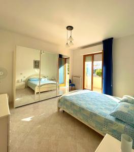 a bedroom with a bed and a large mirror at La casa di Ale in Pineto