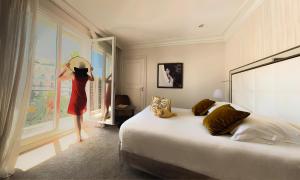 Un ou plusieurs lits dans un hébergement de l'établissement Hôtel Le Canberra