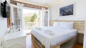 Postel nebo postele na pokoji v ubytování Cunda Piano Otel + 35 fotografií