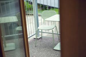 a chair and a table on a balcony at LeonArt Living 12 in Graz