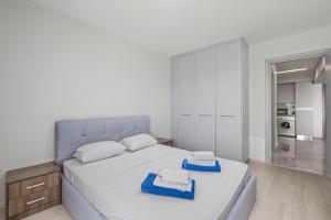 a bedroom with a white bed with towels on it at Latitudes 1 Bedroom Apartment in Meneou +14 photos