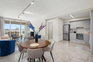 a kitchen and living room with a table and chairs at Latitudes 1 Bedroom Apartment in Meneou