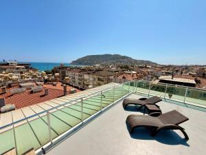 two benches sitting on the roof of a building at SA Apartments! Sea View 2BD Flat in Alanya