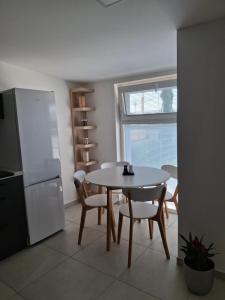 a kitchen with a table and chairs and a refrigerator at Sportbar in Dolní Němčí
