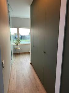 a hallway with a door to a room with a window at Pamario Lizdas in Svencelė