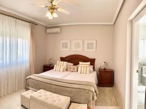 a bedroom with a bed and a ceiling fan at Casa Sara - Private Villa with Private Pool in Ciudad Quesada +33 photos