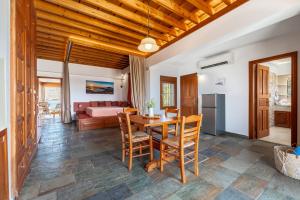 a kitchen and living room with a table and chairs at Arte Suites Pefki in Pefki Rhodes +53 photos