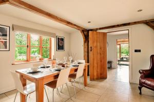 a dining room with a table and chairs at Finest Retreats - Windfall Cottage in Tewkesbury