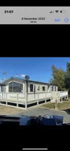 a picture of a house with a white fence at Haven Holiday Park Orchards in Saint Osyth