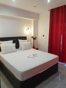 a bedroom with a large bed with a red curtain at Apartments Vesna Luxury & Stefan Ap 10 in Paralia Katerinis