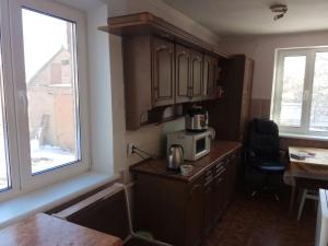 a kitchen with a microwave on top of a counter at Хостел 24 in Vinnytsya
